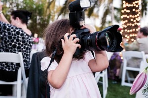 Little girl with a large camera